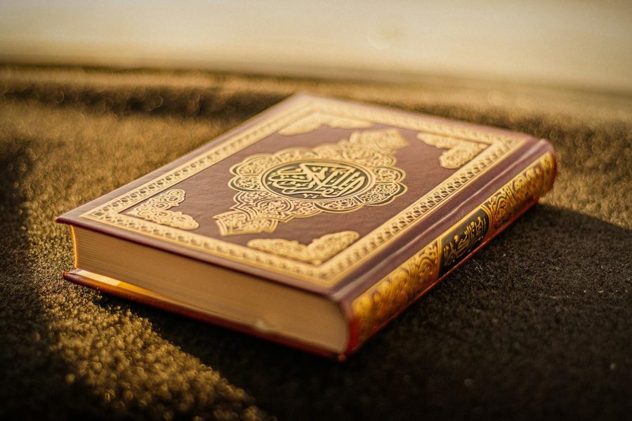 An open Quran on a wooden stand